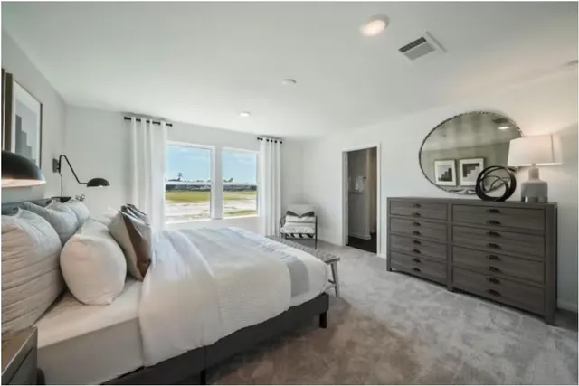 a bedroom with bed and a chandelier