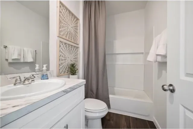 a bathroom with a sink toilet and shower