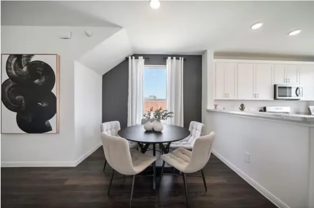 a dining room with furniture and wooden floor