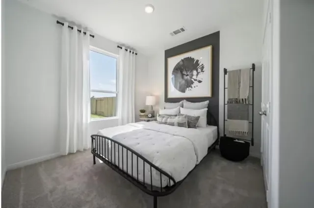 a bedroom with a bed and a window