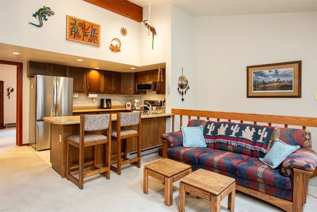 a living room with furniture and a kitchen