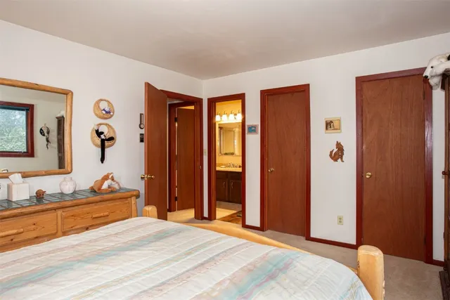 a bedroom with a bed and a dresser