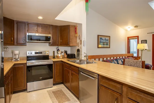 a kitchen with a sink and stainless steel appliances