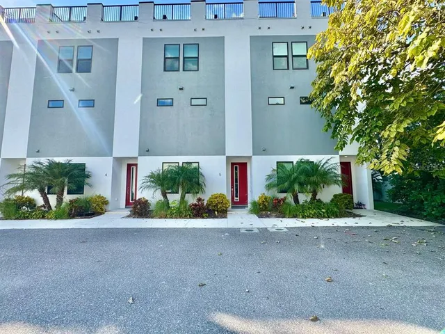 a front view of a house with a yard and a garage
