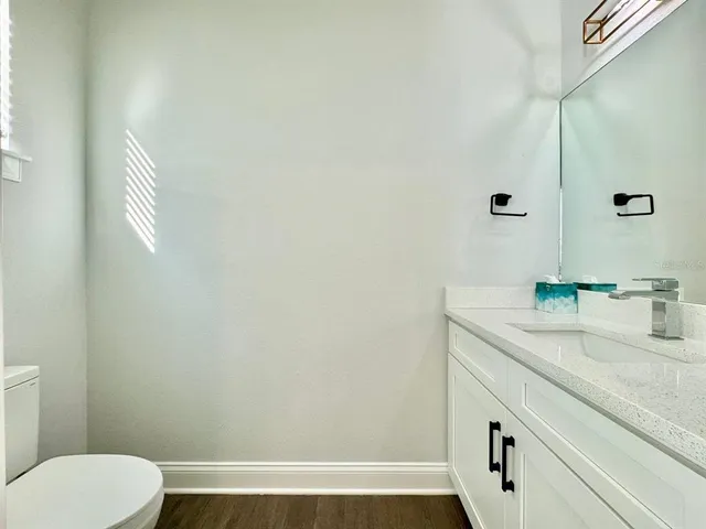 a bathroom with a sink a toilet and a mirror