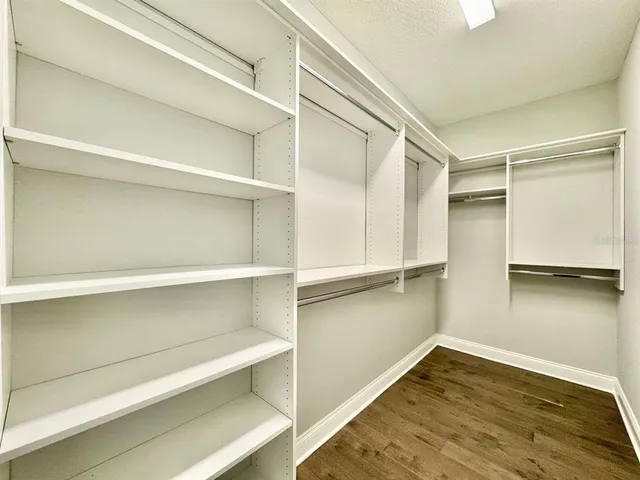 a view of walk in closet with empty racks