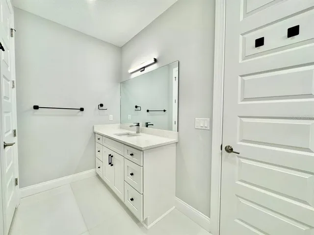 a bathroom with a double vanity sink and mirror