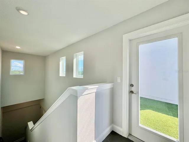 a view of hallway with closet and wooden floor