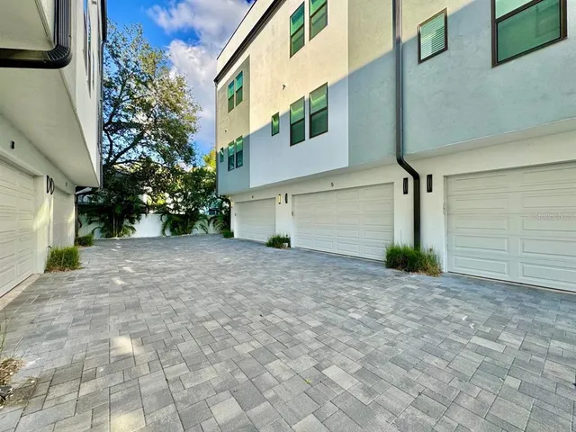 a view of a house with a yard and garage