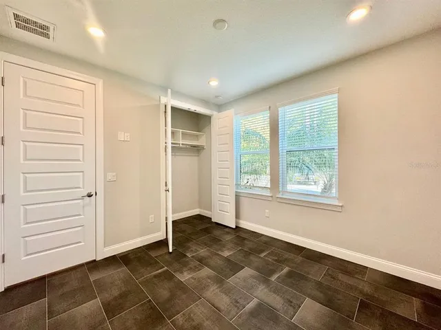 an empty room with a empty space and windows