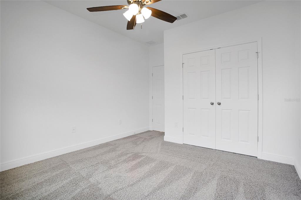 2460 Firstlight Way Winter Park, FL 32792 - Photo 12 of 24 an empty room with a chandelier fan