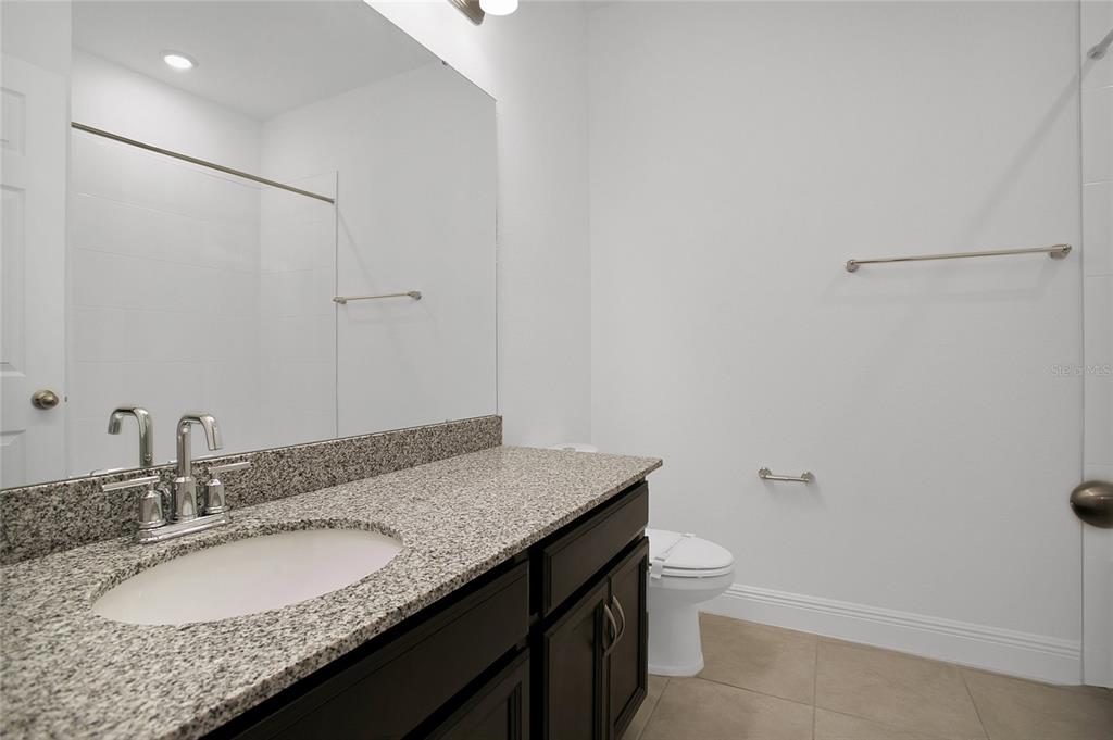 2460 Firstlight Way Winter Park, FL 32792 - Photo 13 of 24 a bathroom with a granite countertop sink and a mirror