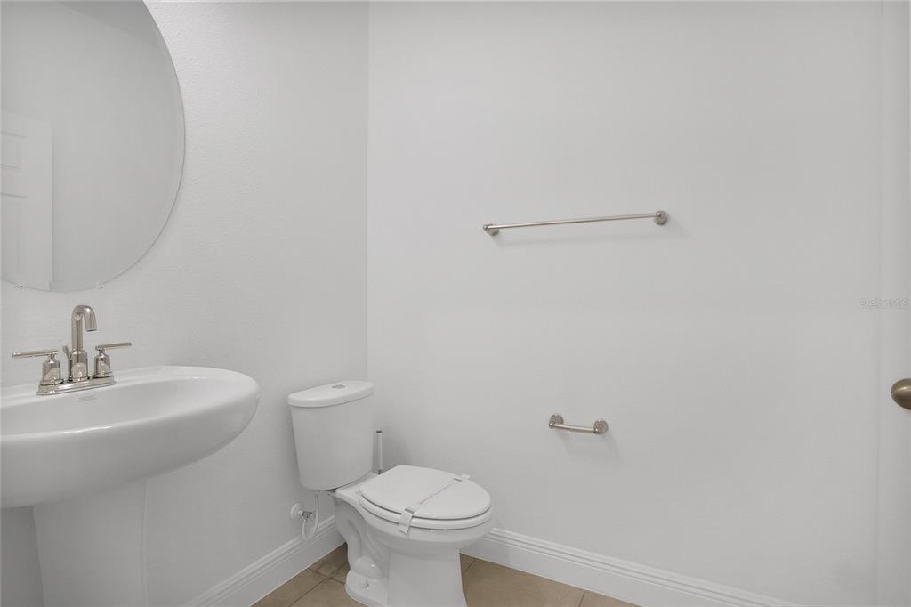 2460 Firstlight Way Winter Park, FL 32792 - Photo 17 of 24 a bathroom with a sink a toilet and a mirror