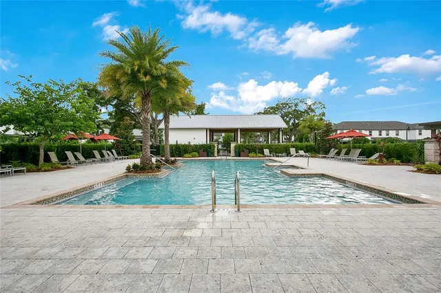 a view of a street with a house and a yard