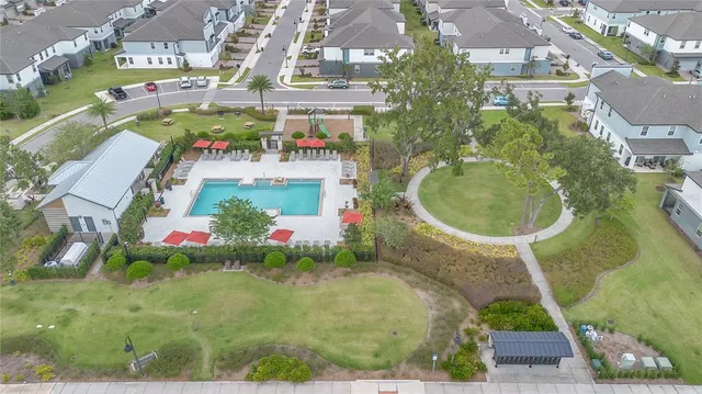 an aerial view of a house with swimming pool and garden