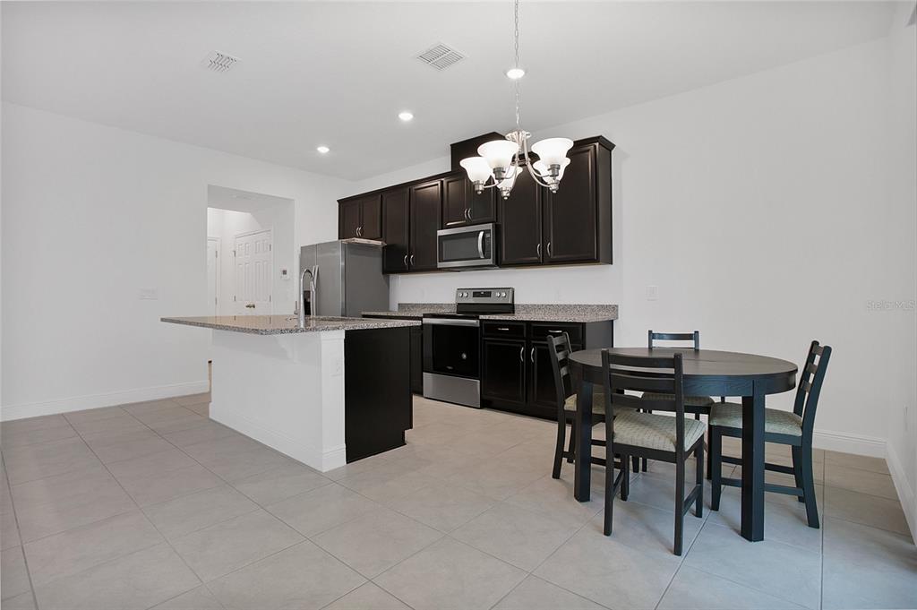 2460 Firstlight Way Winter Park, FL 32792 - Photo 4 of 24 a kitchen with a sink and chairs