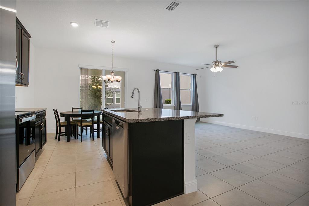 2460 Firstlight Way Winter Park, FL 32792 - Photo 6 of 24 a dining hall with stainless steel appliances a table and chairs