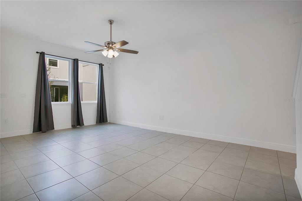 2460 Firstlight Way Winter Park, FL 32792 - Photo 7 of 24 an empty room with chandelier fan and windows