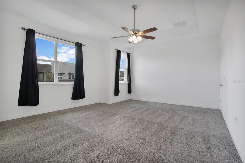 2460 Firstlight Way Winter Park, FL 32792 - Photo 9 of 24 an empty room with windows and fan