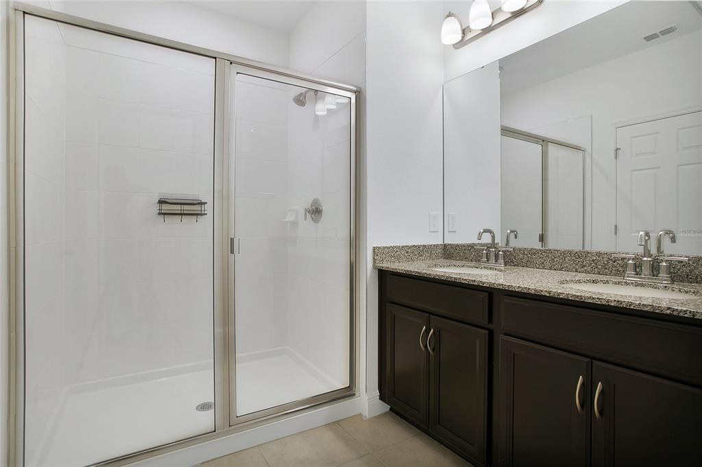 2460 Firstlight Way Winter Park, FL 32792 - Photo 10 of 24 a bathroom with a granite countertop sink and a mirror