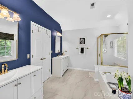 a spacious bathroom with a double vanity sink and a mirror