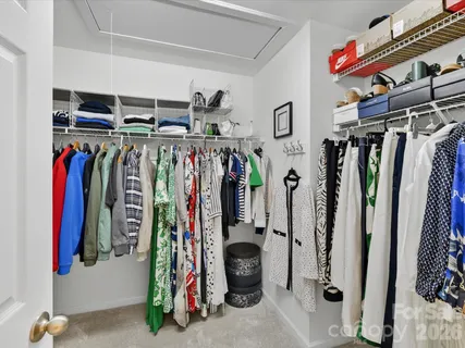 a view of walk in closet with clothes