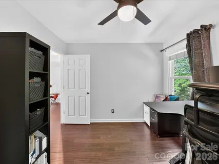 a room with furniture a flat screen tv and a window