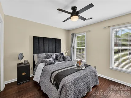 a bedroom with a large bed and a window