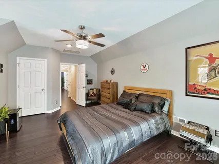 a bedroom with bed and a chandelier