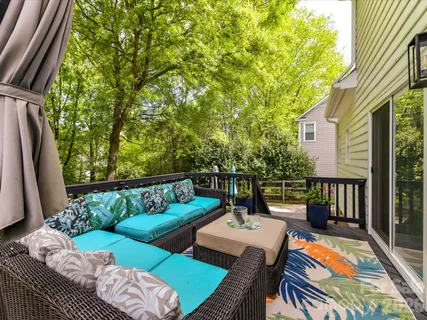 a view of a patio with couches table and chairs and potted plants