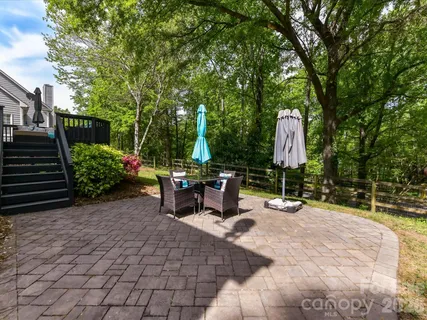 a view of a backyard with sitting area