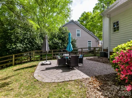 a view of a backyard with plants and a patio