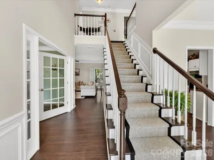 a view of entryway and hall with wooden floor
