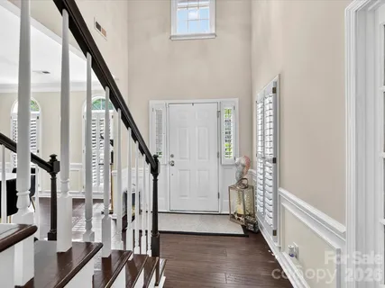 a view of an entryway with wooden floor and stairs