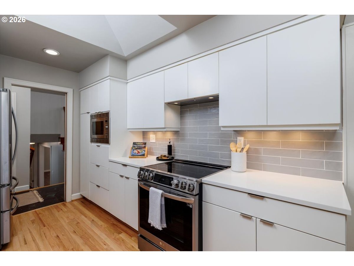 175 Northwest 95th Avenue Portland, OR 97229 - Photo 15 of 46 a kitchen with a sink stove and refrigerator