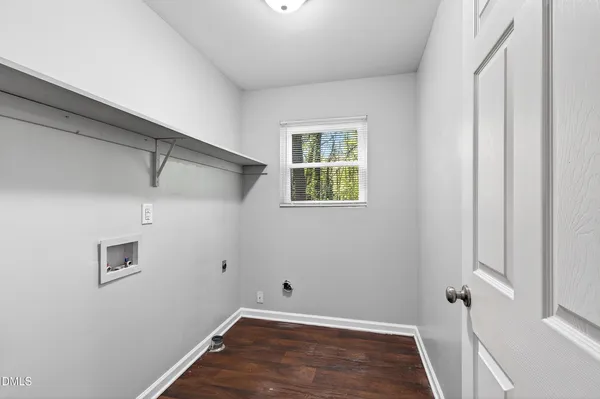 a view of a room with wooden floor and window