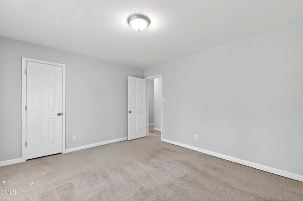 a view of an empty room and a window