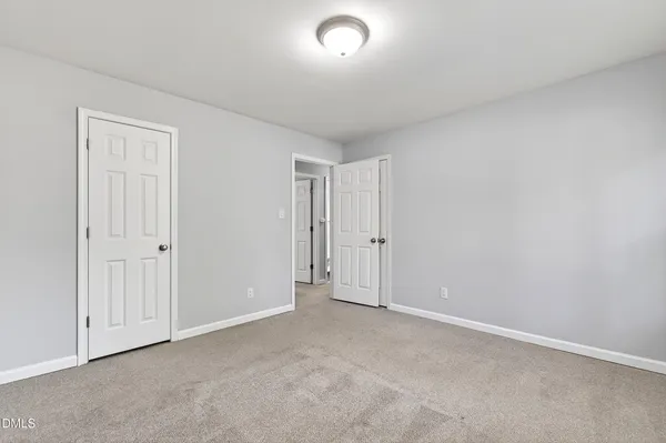 a view of an empty room and a window