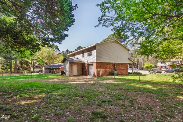 a house view with a sitting space and garden