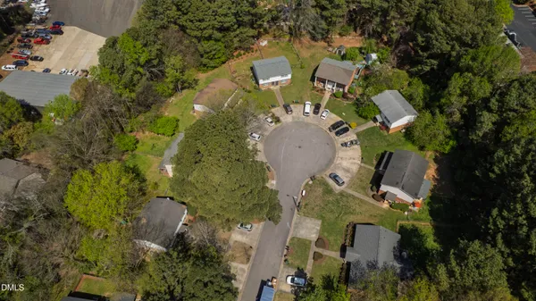 an aerial view of a house with outdoor space and sitting area