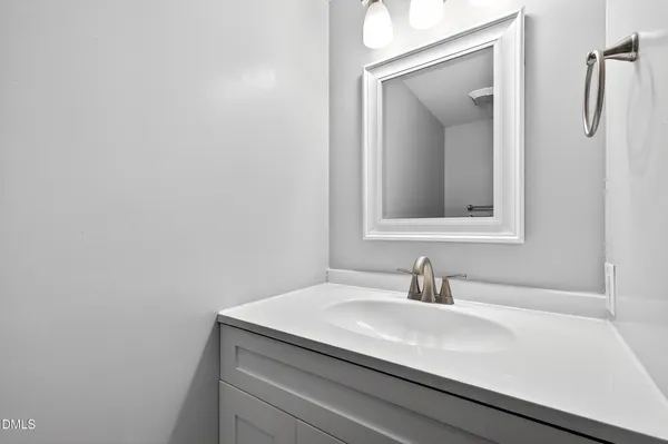a bathroom with a sink and mirror