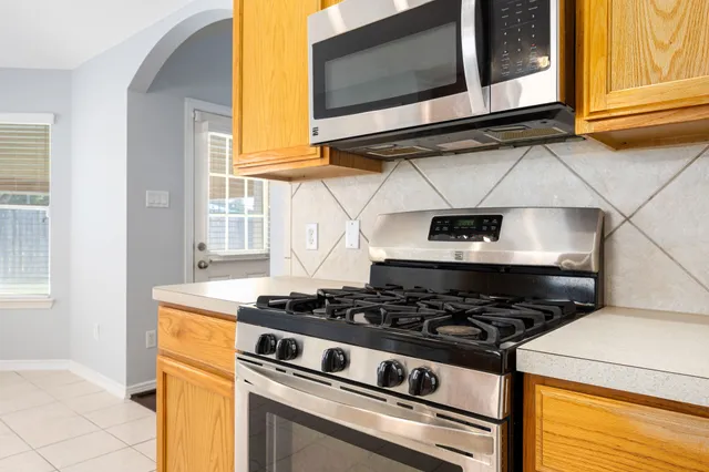 a stove top oven sitting inside of a kitchen
