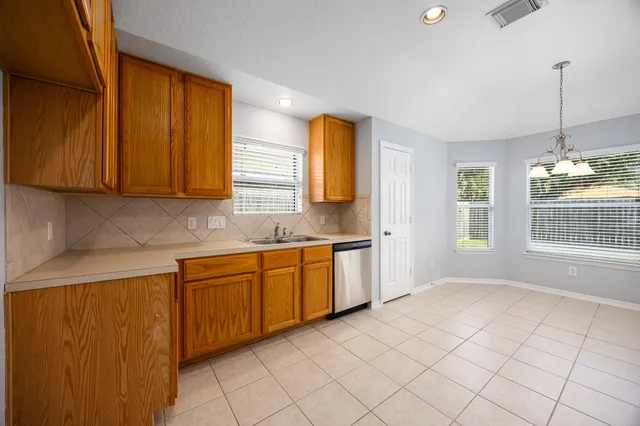 a kitchen with stainless steel appliances granite countertop a sink and a cabinets