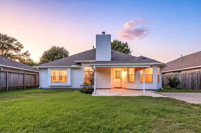 a front view of a house with a yard and outdoor seating
