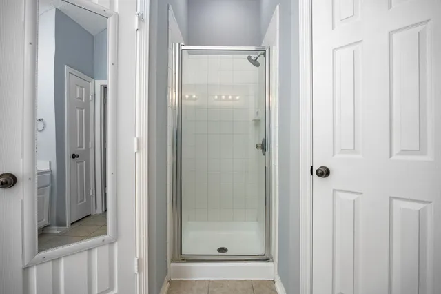 a bathroom with a glass shower door and a sink