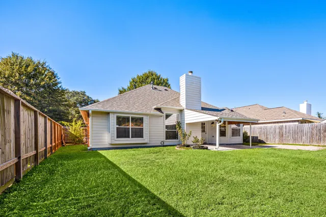 a front view of a house with yard and green space