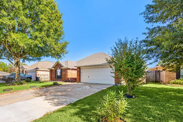 a front view of house with yard and green space