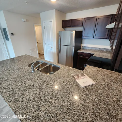 a kitchen with a refrigerator and a sink