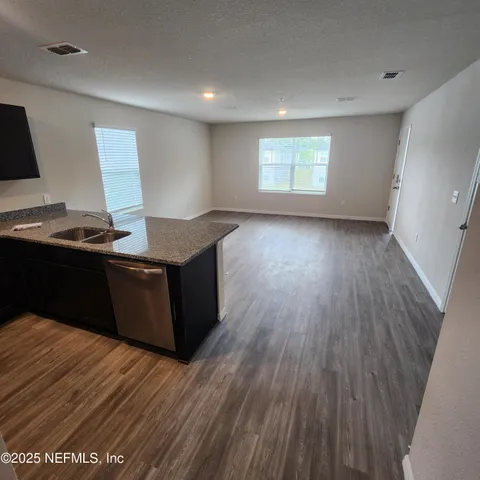 a room with wooden floor and window