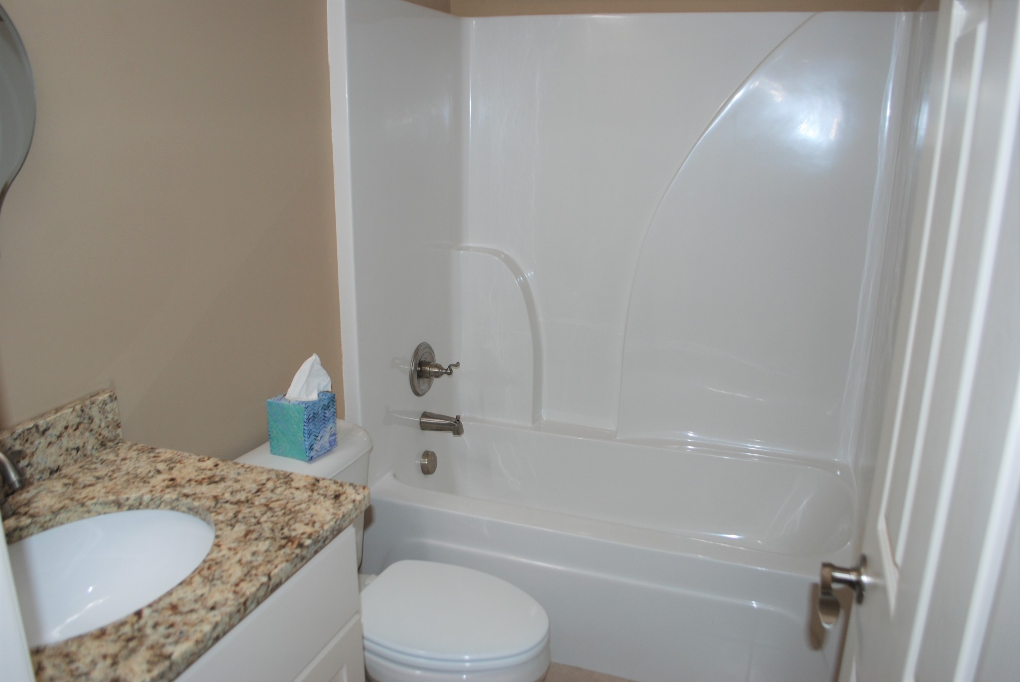 82 Diamond Road Manchester, TN 37355 - Photo 13 of 18 a bathroom with a granite countertop sink a toilet and bathtub
